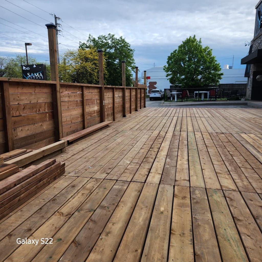 Outdoor wooden deck with privacy fence and matching posts