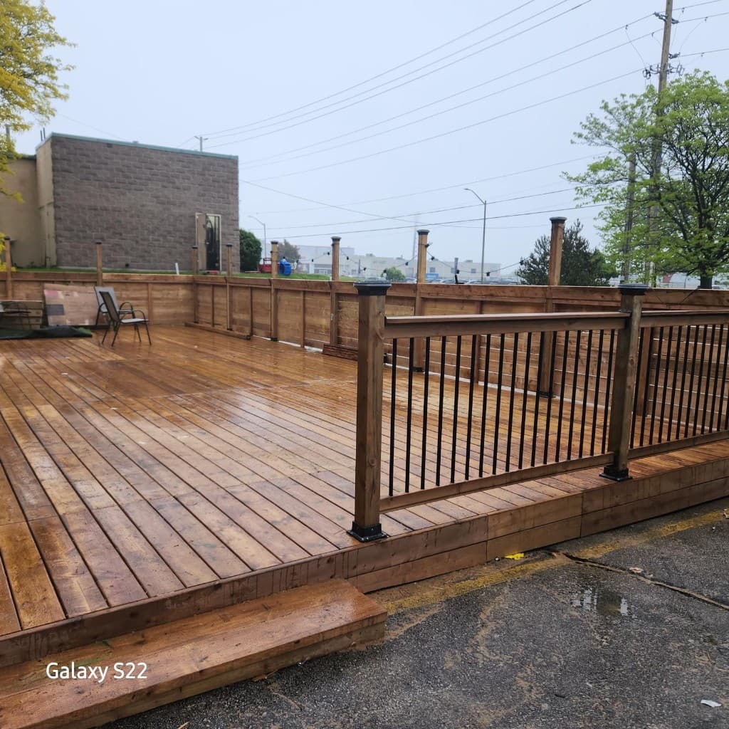 Spacious wooden deck with perimeter railing and modern design