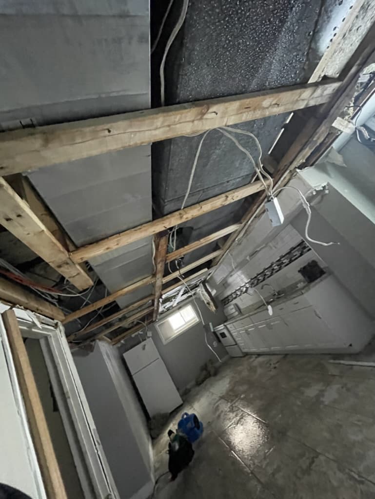 Water-damaged basement ceiling opened up after flooding in a Niagara Region home