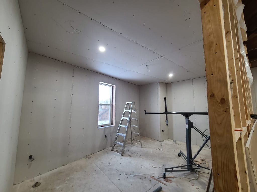 Drywall installed in a stair and landing space before taping